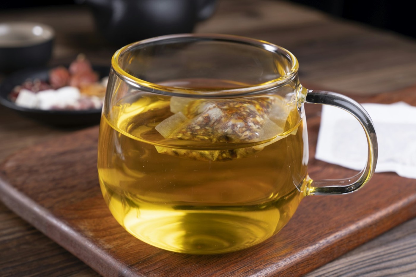 Glass of golden anise tea on a wooden board