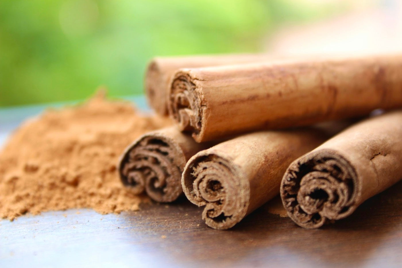 Ceylon cinnamon quills next to ground cinnamon