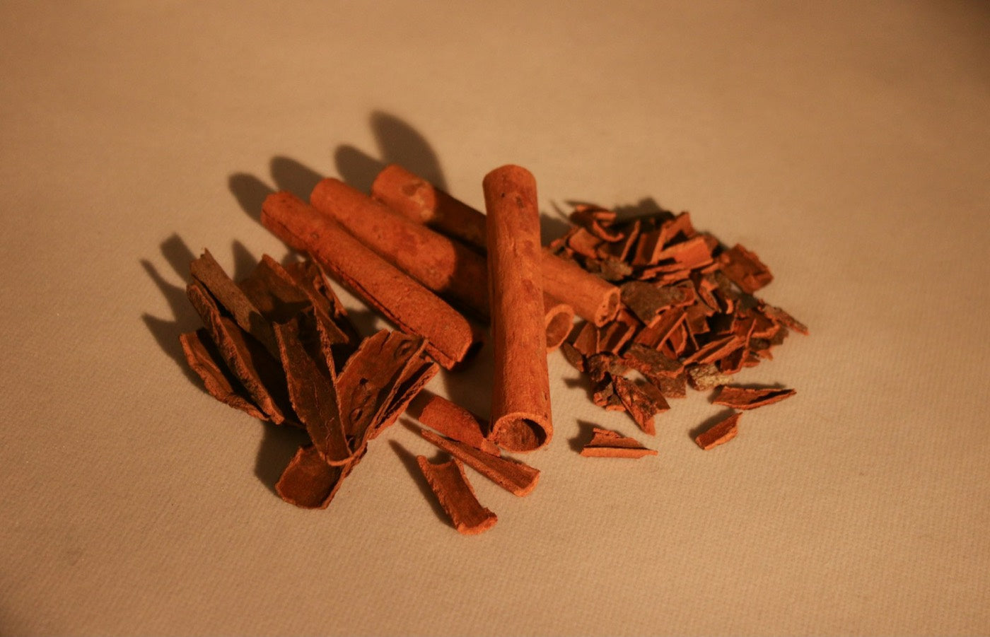 Pieces of thick cinnamon bark on a wooden table