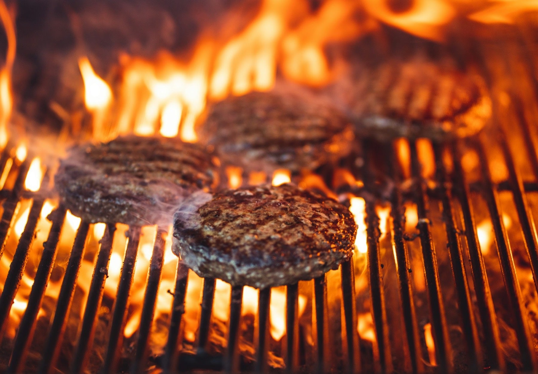 Burgers on a flaming grill