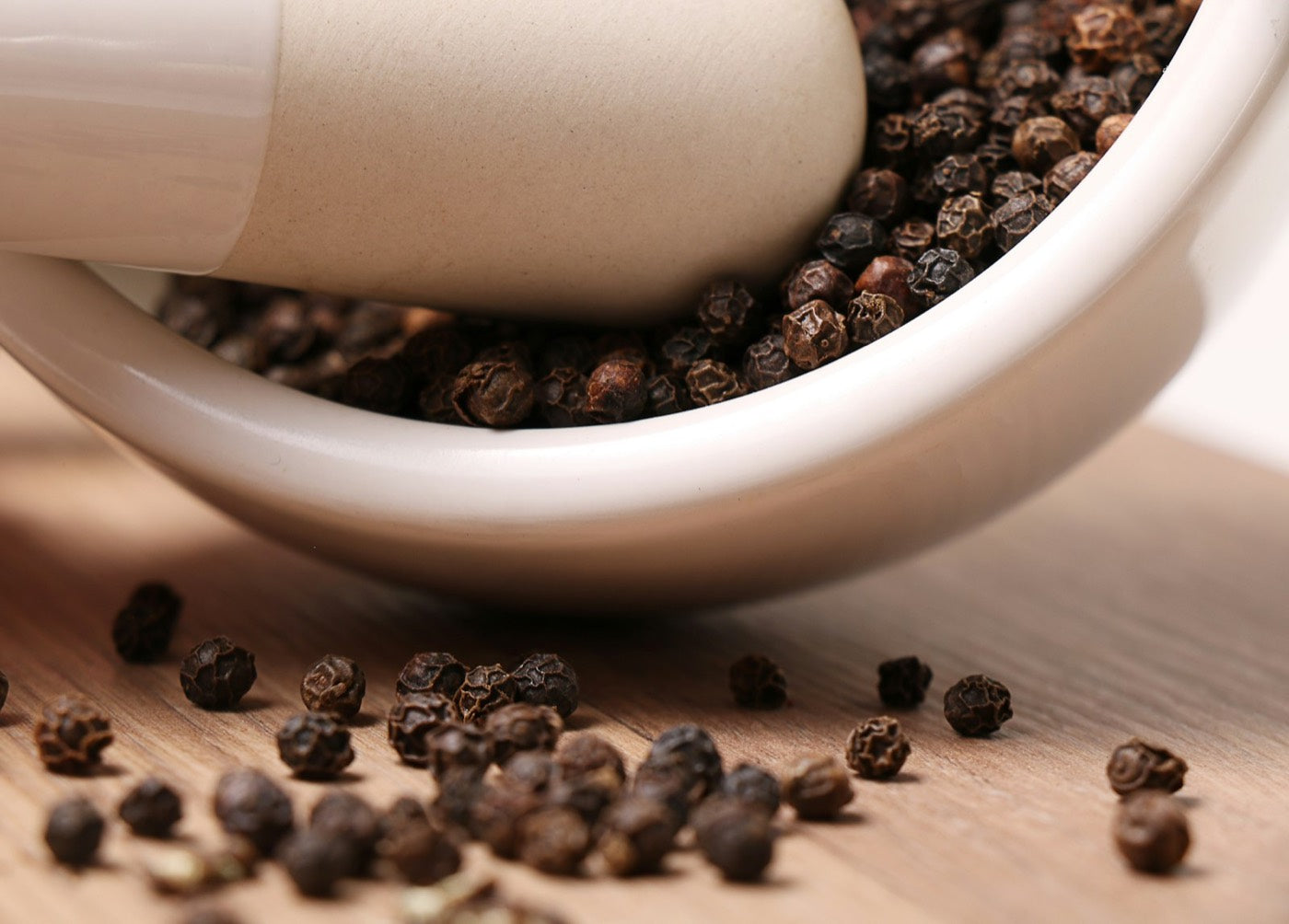 Black peppercorns in a mortar